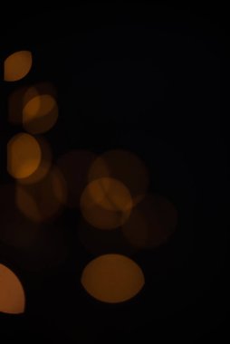 Golden glitter falling sparkle background on black with side copy space