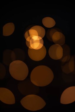 Golden glitter falling sparkle background on black with side copy space