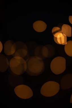 Golden glitter falling sparkle background on black with side copy space