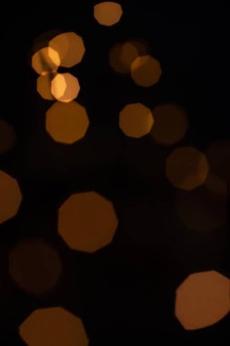 Golden glitter falling sparkle background on black with side copy space