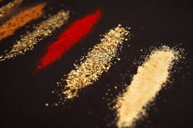 Siyah arka plana yayılmış çeşitli baharatlar. Arkaplan resmi