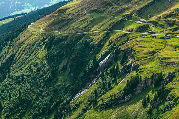 Summer mountain landscape with green grass and mountain peaks. Swiss Alps