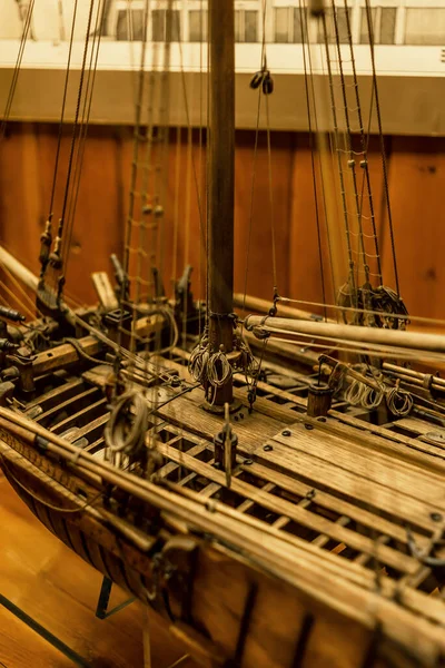 Wooden ship model close-up, mast, guns, cables - details of a frigate toy model