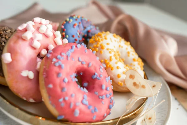 Top view of assorted glazed donuts. Colorful donuts with icing as background with copy space. Various colorful glazed doughnuts with sprinkles.