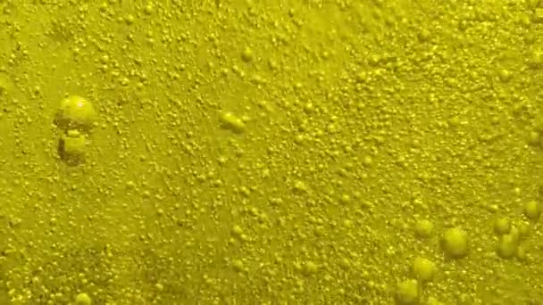 分子泡が平面に流れる透明化粧品ジェル液 黄色のゲルにはたくさんの気泡があります マクロショット — ストック動画
