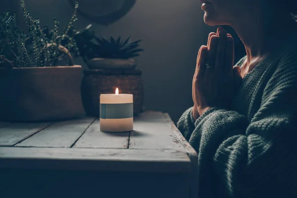 禅の家庭で1人の女性のために祈るキャンドルライトの前で生活の瞑想のように 緑のムードカラースタイル 精神衛生の概念 信仰と宗教 暗い室内でキャンドルライト — ストック写真