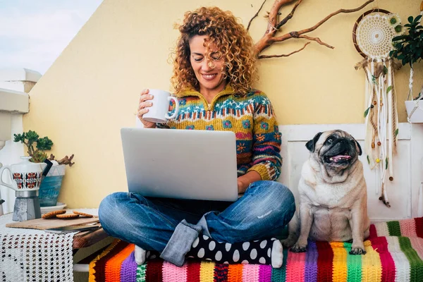 People and dog best friends forever together. happy woman smile and use laptop sitting near her lovely friend companion dog pug. Animal and business lifestyle moment. Modern leisure activity