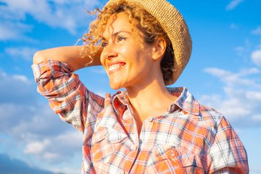  happy woman admiring outdoors and sun in outdoor leisure activity alone. Joyful face expression in female people, middle age. Healthy lifestyle and summer vacation day. 