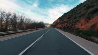 Long empty road and car perspective with mountains on both sides. Traveling in scenic place with amazing background. Transport on freeway view from automobile. Rocky Mountains outdoor park place.