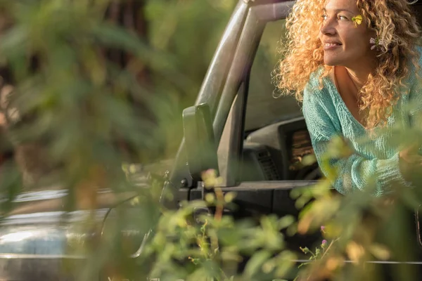 stock image Car travel adventure and love for nature concept lifestyle. happy woman outside the vehicle window admiring nature around in the bush. Concept of transport and vacation in wild outdoors road trip