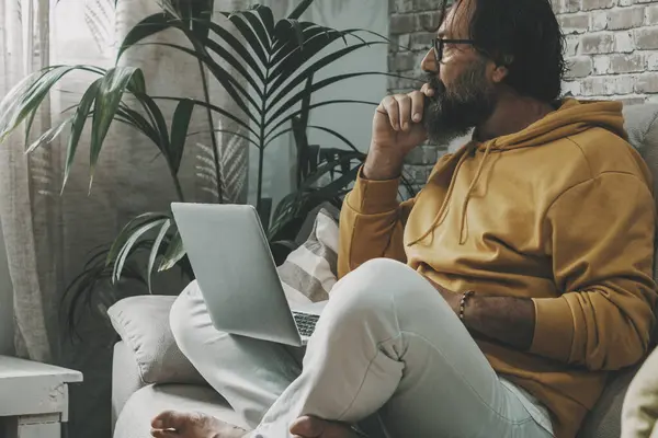 Mature Man Sitting Home Crossed Legs Working Laptop Modern People – stockfoto