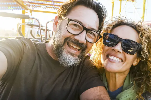 一对夫妇在云霄飞车上在空气中逗乐 阳光灿烂的下午 充满乐趣 闲暇时间和快乐的概念 — 图库照片
