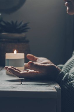Diz çöküp mum başında dua eden Hristiyan bir kadın. Dini inancı ve maneviyatıyla ilgili rehberlik arıyor. Hristiyanlığın ruhu ve Tanrı 'nın iyiliğine olan inanç
