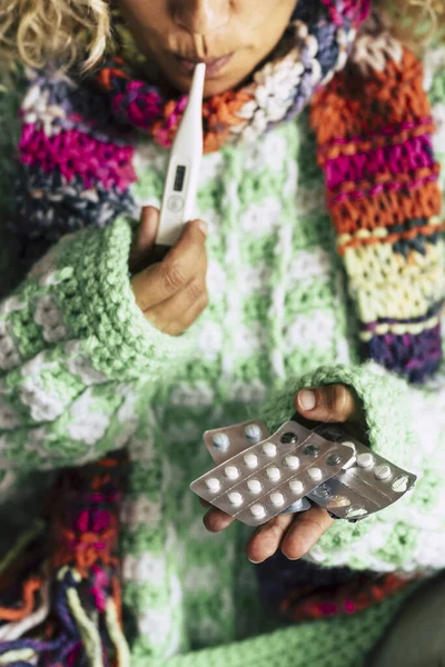 SIck woman at home check fever temperature and take pills medicine to fight influenza flu and cough - coronavirus covid-19 breakout people with science and care