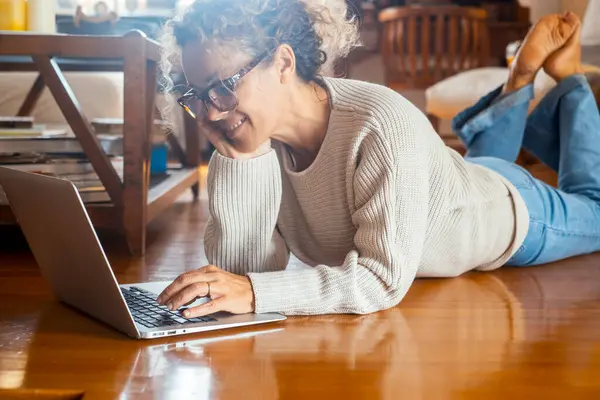 Relaxed Woman Using Computer Home Laying Wooden Floor Modern Apartment — Stock Photo, Image