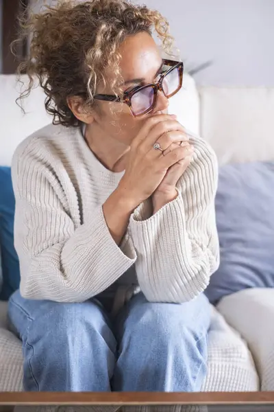 Worried Adult Woman Sitting Sofa Home Clasped Hands Thinking Problems — Stock Photo, Image