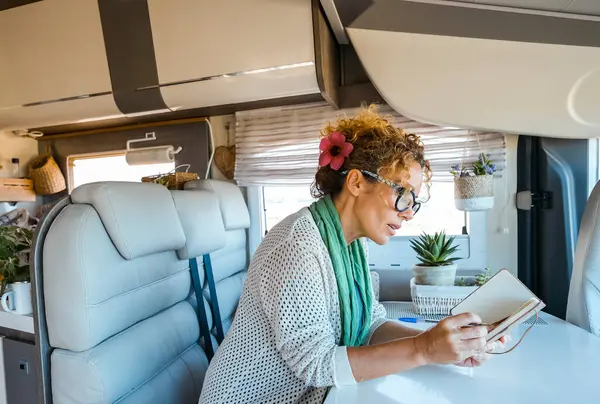 One Woman Reading Book Writes Plans Sitting Camper Van Motorhome Стоковое Изображение