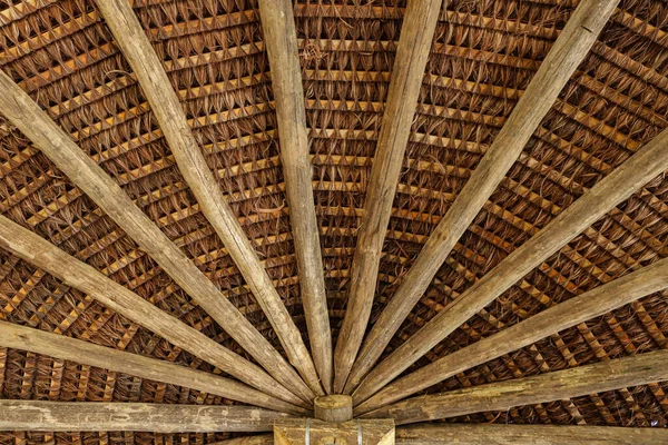 从下往上看带有木薯的屋顶的结构 显示其木结构和稻草编织 — 图库照片
