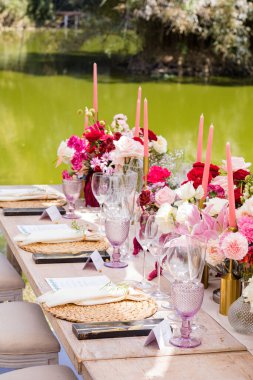 Mumlar ve çiçeklerle hazırlanmış düğün masası.
