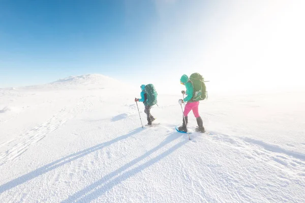 Two Girls Walk Mountain Path Snowshoes Walking Snow Hiking Mountains — стоковое фото