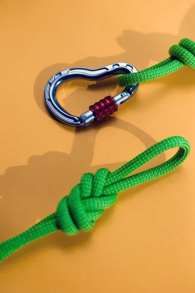 Carabiner and knot from a climbing rope. Equipment for climbing and mountaineering. Knot eight. Safety rope.