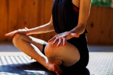 Eller yukarı. Genç atletik kadın antrenör yoga eğitmeni bireysel antrenman yapıyor. Denge pozisyonu, modern spor salonu, sağlıklı yaşam tarzı konsepti. Doğada spor.