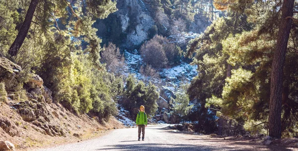 stock image A boy with a backpack walks through the forest, a child studies wildlife, a child stands alone among the trees, a portrait of a boy. Travel and hiking.