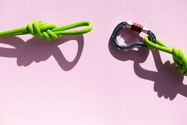 Carabiner and knot from a climbing rope. Equipment for climbing and mountaineering. Knot eight. Safety rope.