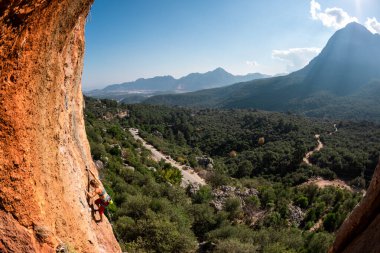 The girl climbs the rock. Climber trains on natural terrain. Extreme sport. Lessons on the street. A woman overcomes a difficult climbing route in Turkey. sports and adventure.