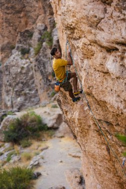 climber climbs the wall. a man is engaged in sport climbing. sport and active lifestyle.