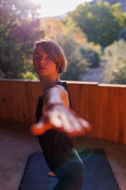 Sokakta yoga yapan bir kadın. Formda bir kadın esneme egzersizleri yapıyor. Eller yakın plan.. 