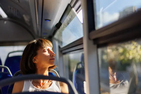 young woman sitting on a public bus. Girl on the bus.