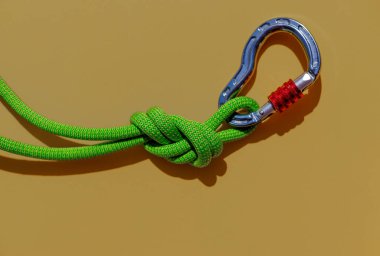 two ropes with secure knots are connected by a carabiner. Equipment for rock climbing and mountaineering. reliable connection. Safety rope. concept of reliability and strength.