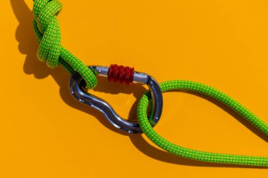 two ropes with secure knots are connected by a carabiner. Equipment for rock climbing and mountaineering. reliable connection. Safety rope. concept of reliability and strength.