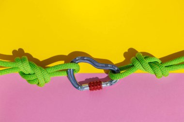 two ropes with secure knots are connected by a carabiner. Equipment for rock climbing and mountaineering. reliable connection. Safety rope. concept of reliability and strength.