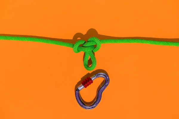 two ropes with secure knots are connected by a carabiner. Equipment for rock climbing and mountaineering. reliable connection. Safety rope. concept of reliability and strength.
