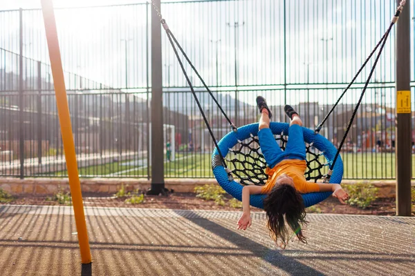 Çocuk salıncağında mutlu bir çocuk. Çocuklar için yaz ziyareti. Oğlan yaz günü salıncakta eğleniyor. neşe ve eğlence.