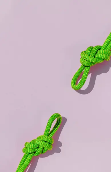 two ropes with secure knots. concept of reliability and safety. climbing rope with a knot lies on a colored background. rope with a knot.