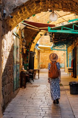 Şapkalı ve sırt çantalı güzel bir gezgin kız tarihi şehri keşfediyor. seyahat ve macera.