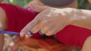 Kaya tırmanıcısı parmaklarını bantla sarar. Kadın elleri yakın. Hasara karşı koruma. Atlet yaraları iyileştirir.