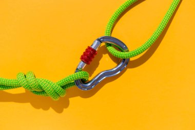 two ropes with secure knots are connected by a carabiner. Equipment for rock climbing and mountaineering. reliable connection. Safety rope. concept of reliability and strength.