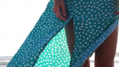 İnce kız sahilde duruyor ve gün batımını seyrediyor. Şık elbiseli bir kız sahilde yalınayak yürüyor. Güzel bronzlaşmış bir kız, deniz kenarında bir yaz tatilinin tadını çıkarıyor..
