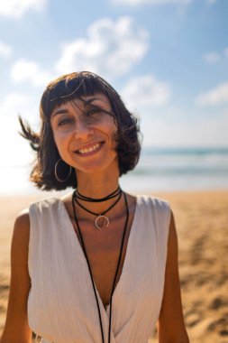 Yaz havası. Kız sahilde eğleniyor. Kumsalda dinlenen mutlu genç kız. Mutlu kadın. Kız kumsalda duruyor. Kumsalda dinlenmek..