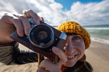 young girl with a camera. photographer with camera. Stylish girl with a film camera. takes a shot. adventures and travel. clipart