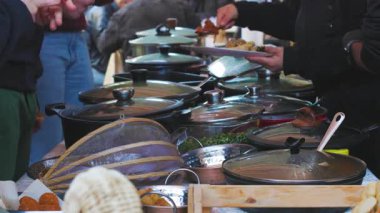  Arap yemekleri. İnsanlar yemek sipariş eder. Tabaklarla dolu bir masa. Açık büfe, sokak yemekleri.. 