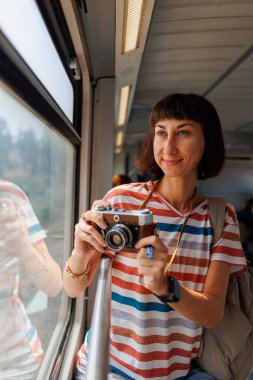 Tren yolculuğu. Genç bir kadın tren yolculuğunun ve kameranın keyfini çıkarıyor. Kamerayı kapat. Kız film kamerası kullanıyor..