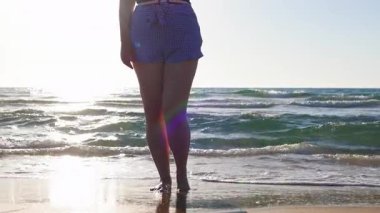 Ayrıca sahilde durmuş tatilinin tadını çıkaran cüsseli bir kadın. Yaz tatilindeki kadın turist, yaz havası. Sahildeki kız..