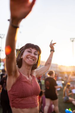 Genç bir kadın konserde dans ediyor, geceleri açık havada eğleniyor. Konserde müzikten hoşlanan seksi bir kadın. Neşeli kız dans partisinde takılıyor. İnsanlar festivalde eğleniyor..