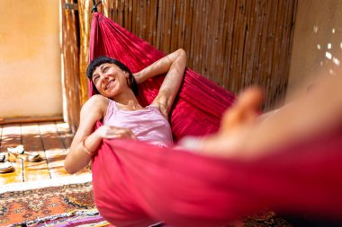 Hamakta yatan kız. Yaz tatilinin tadını çıkaran mutlu genç bir kadın. Romantik tasasız ruh hali konsepti. Yaz havası.