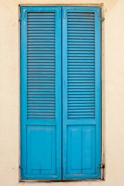 Vintage blue wooden shutters on a window close up